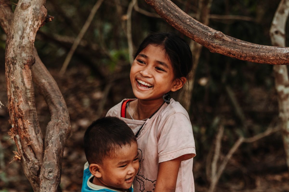 Two children laughing outdoors