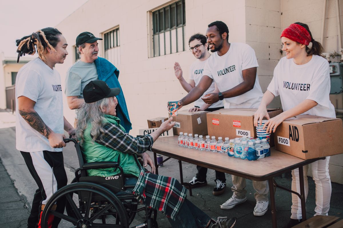 Volunteers handing out water and aid